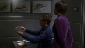 Archer holding nucleonic particle.jpg